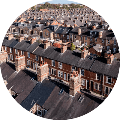 A birds eye shot of terraced houses on different streets.
