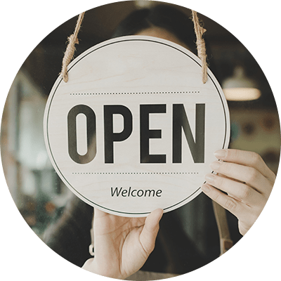 A close up of someone flipping a sign to open their shop.