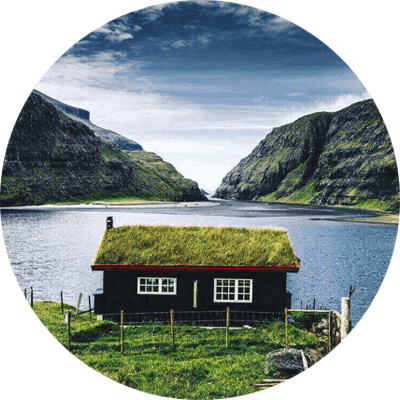 A small cottage with nothing else around looking at a view of a lake going into the sea (1)