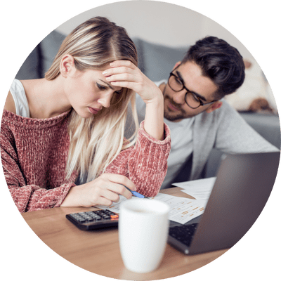 A frustrated young couple involved in a property chain trying to work something out on a laptop.
