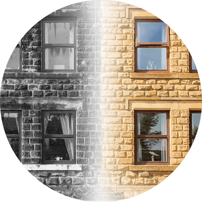 Brick house split between black and white and colour.