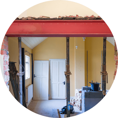 Building construction work in UK residential property with new wall opening.