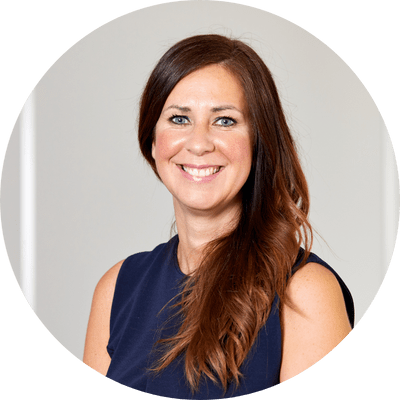 Clare a professional woman with long brown hair smiling.