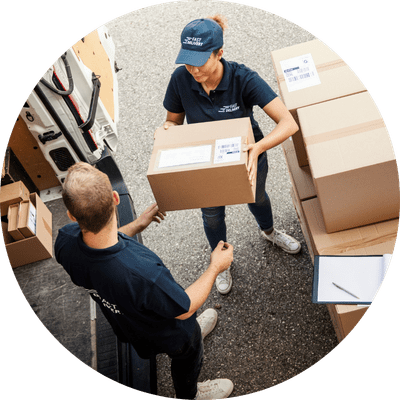 Female delivery driver with a package of supplies for a business owner.