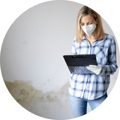 Female landlord looking at checklist in damp room.