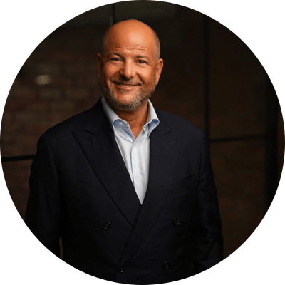 Image of Marc Goldberg, CEO Group Sales & Distribution at Together, smiling at the camera casually wearing a dark suit without a tie.