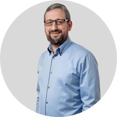 Rabbi Maxim Cohen of the Jewish Lending Institute smiling at the camera wearing a light blue shirt.