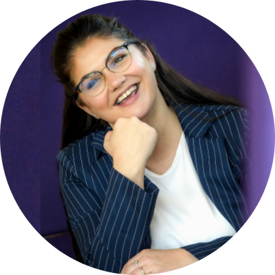 Michelle Walsh, professional woman in glasses and blue suit jacket smiling.