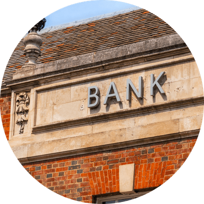 An old, historic building that was previously a bank with the word "Bank" outside, in the town of Warwick in the UK.