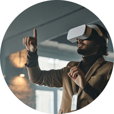 Professional bearded man in a smart casual beige jacket stood up and using a VR headset at work.