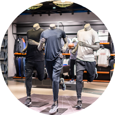 Three male mannequins in a sports store in sports attire and running poses.