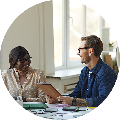 man and woman smiling at each other in an office