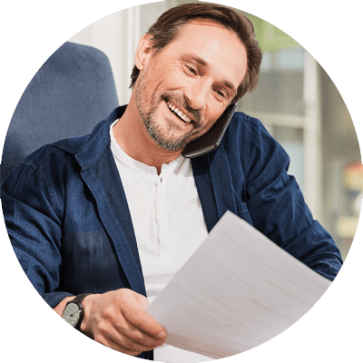 Smart man on mobile phone reading paper documents