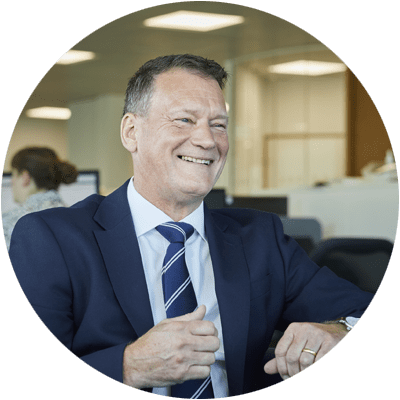 Well dressed man in a navy suit laughing 2