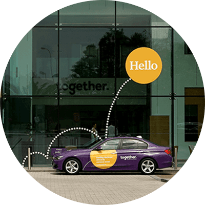 Together building with a purple together branded car parked outside.