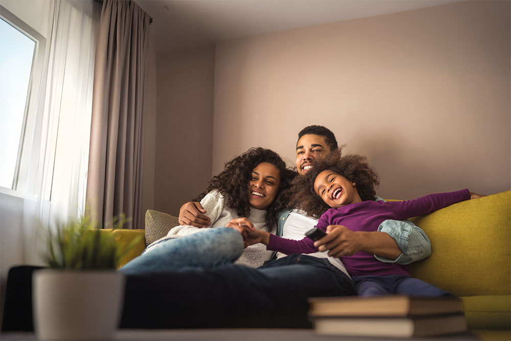 A family relaxing together at home with their child