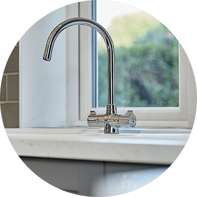 A close up of a counter with a newly fitted sink.