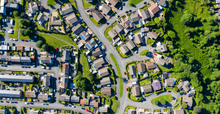 A bright aerial view of a suburban residential estate.