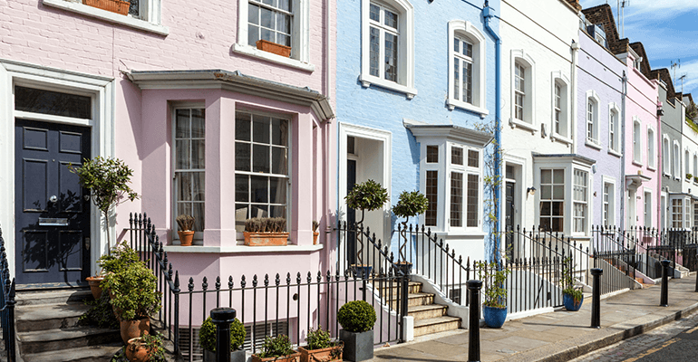 A long shot of pastel coloured terraced houses.