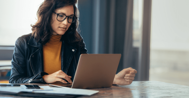 Asian Business woman busy working on laptop computer at office.