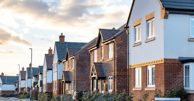 Houses in England with typical red bricks at sunset.