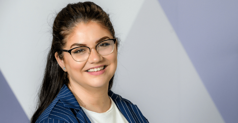 A professional woman, Michelle Walsh, smiling at the camera.