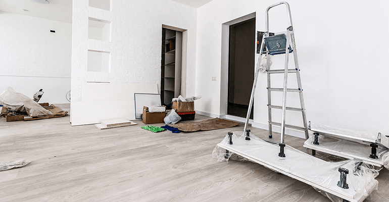 room in a property being renovated with decorating equipment in it - s