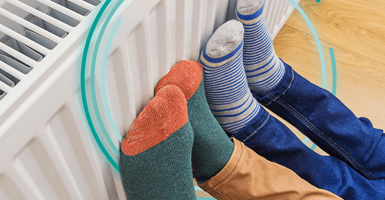 Two pairs of feet with different coloured socks on a radiator - small2