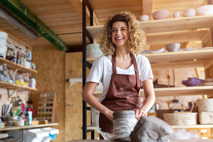 Lady creating decoration made out of clay - m l