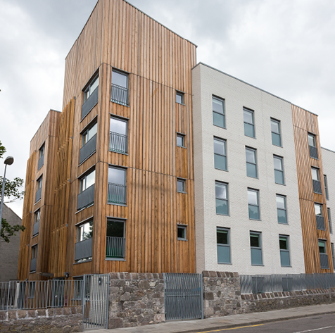 Multi-story wood paneled flats.