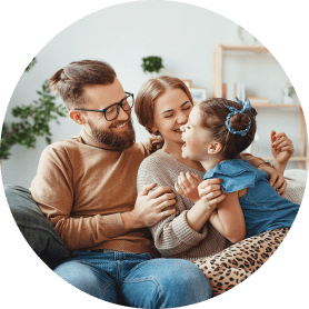 young couple sat laughing with a young girl