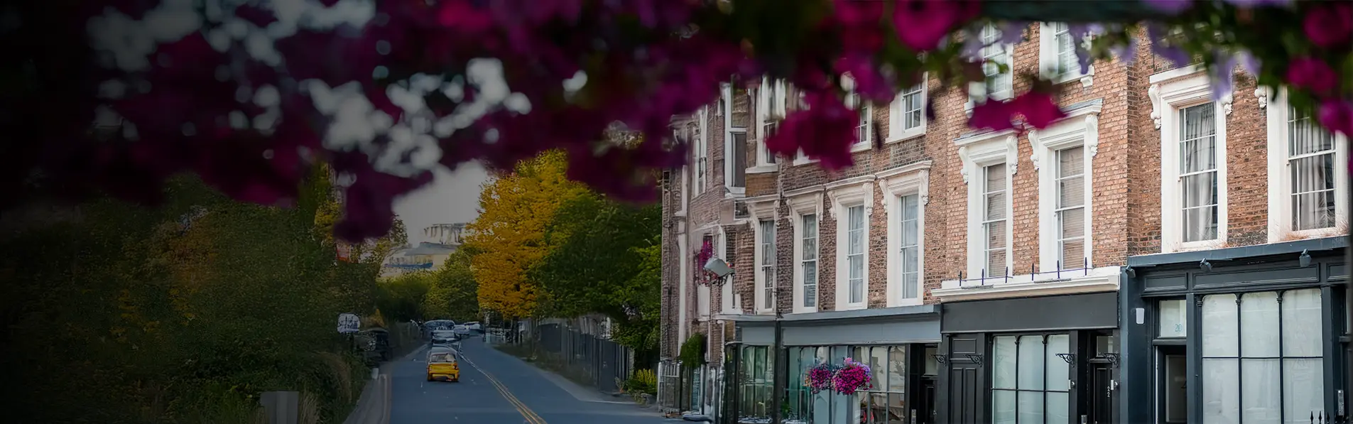 A close up shot of flats above shops on a main road.