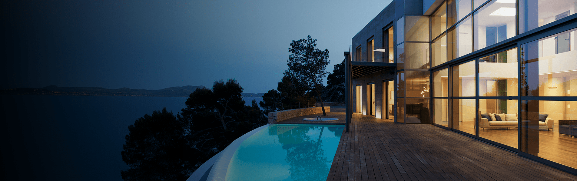 A house on the edge of a hill with an infinity pool outside.