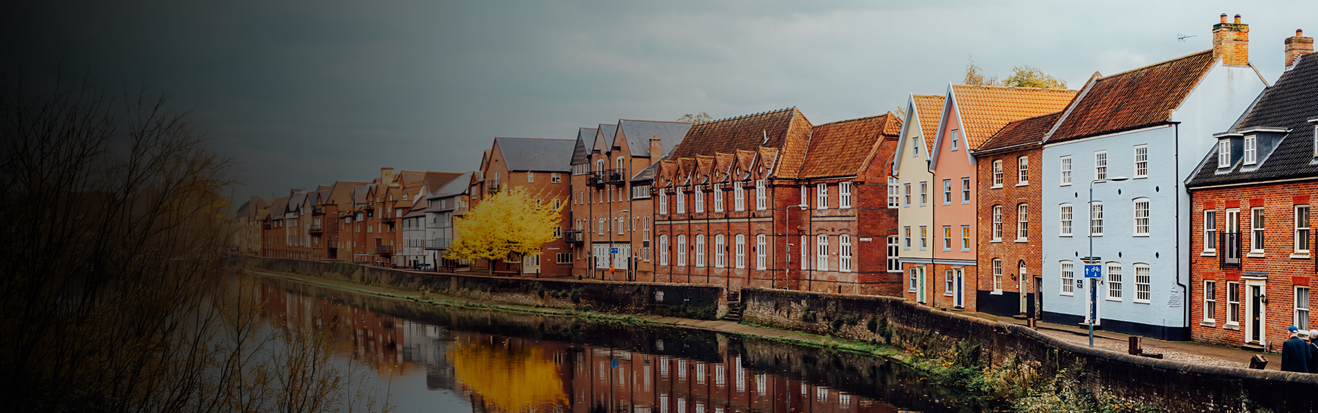 A line of houses by the side of a canal.