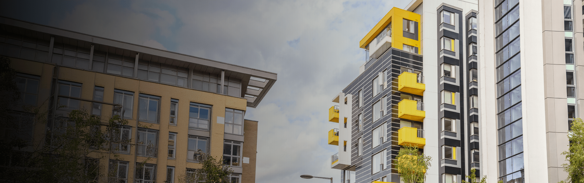A wide shot of a tall building of apartments.
