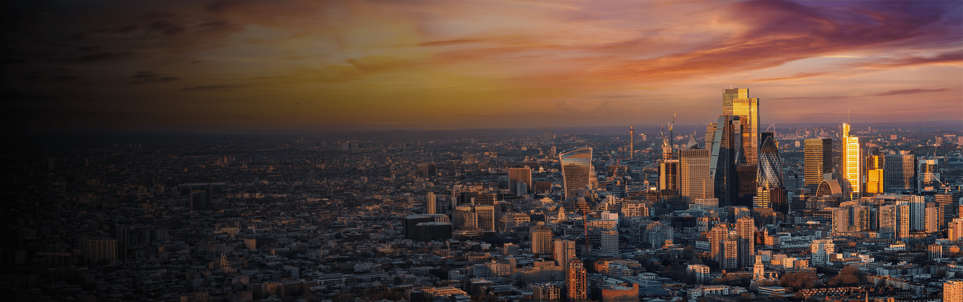 A wide shot of the City of London during a sunset.