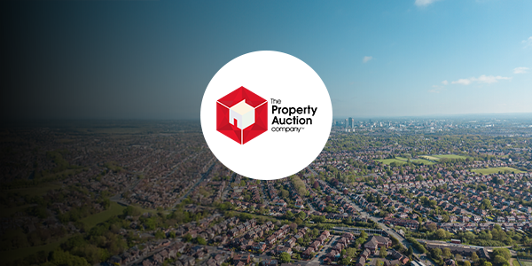 A birds eye view of Manchester with The Property Auction Company logo over it.