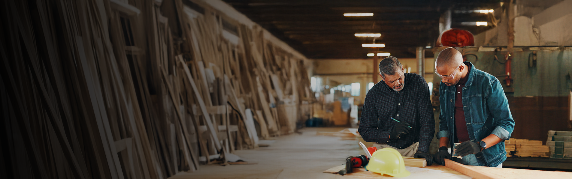 Two men working together in a carpenter workshop.