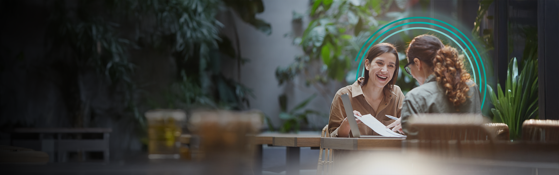 Two women sat at a table talking between themselves.