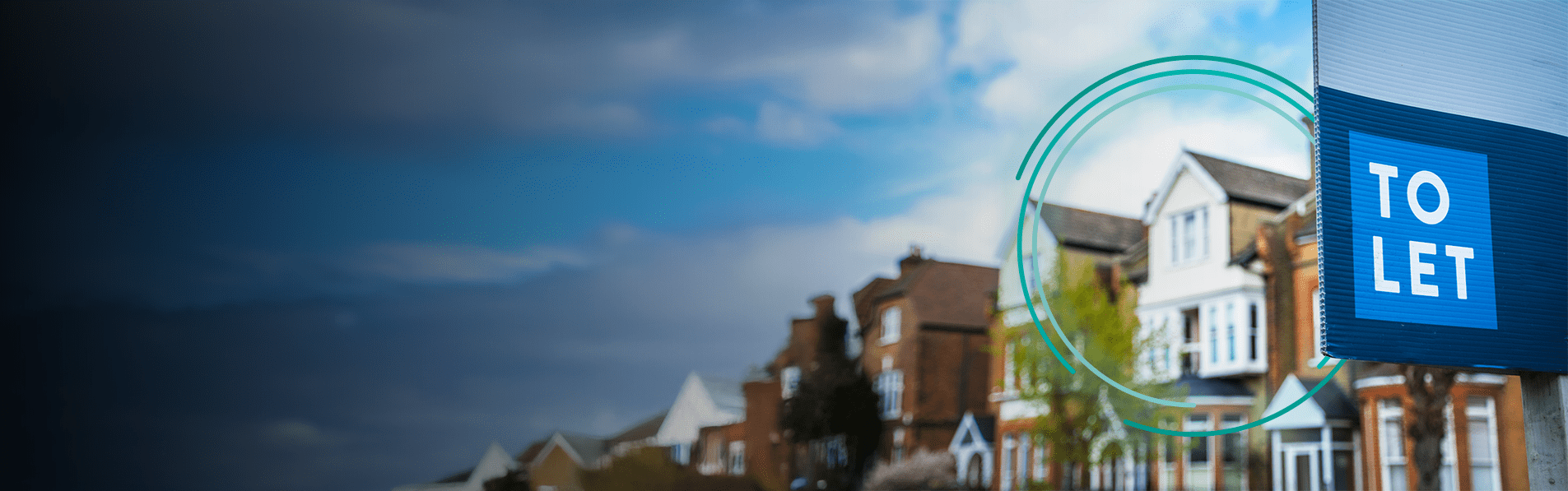 A blurred background of terraced houses with a to let sign in front of them.