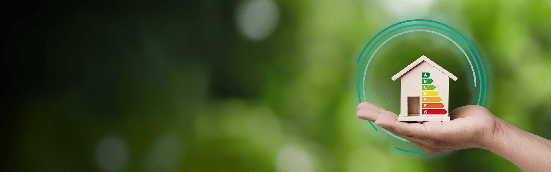 A blurred green background with a hand holding a wood house with EPC ratings on it.