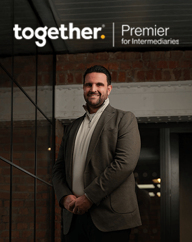 Dan Narwal standing in a modern brick warehouse smiling with a Together Premier Intermediaries logo.