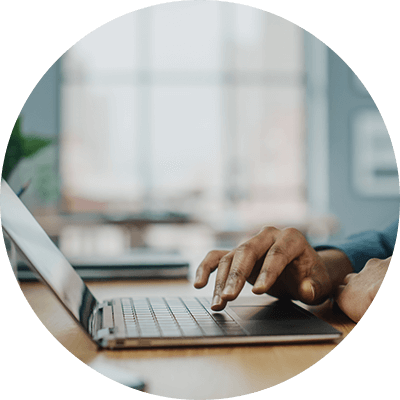 A close up of someone typing on a laptop.