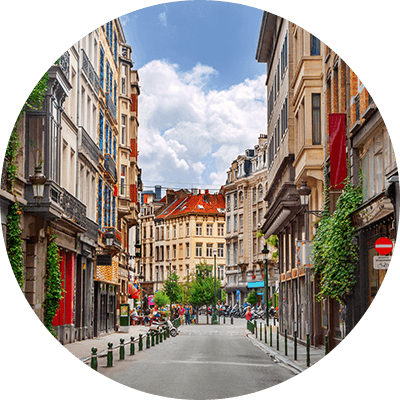 A wide shot of a long street with different apartments on both sides.