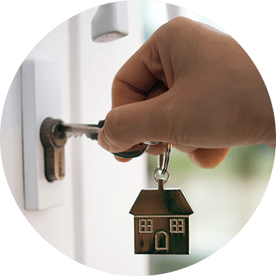 A close up of someone opening a door with a key.