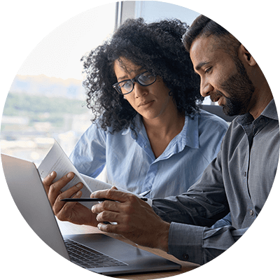 A close up of people looking at a piece of paper.