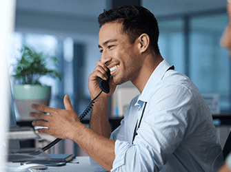 A close up of a man talking on a phone.