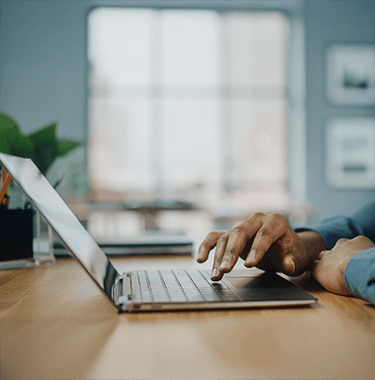 A close up of a man on a laptop.