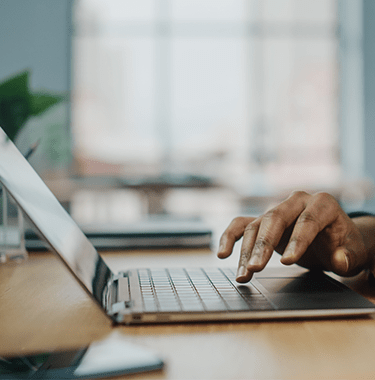 A close up of a man using a laptop.