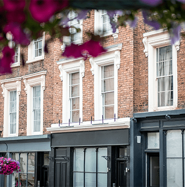 A wide shot of flats above shops.